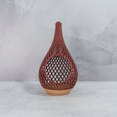 "Sitting, front-facing, empty WOOD AND RUBY RED TEARDROP planter, showcasing its elegant wood base and bold ruby red pattern."